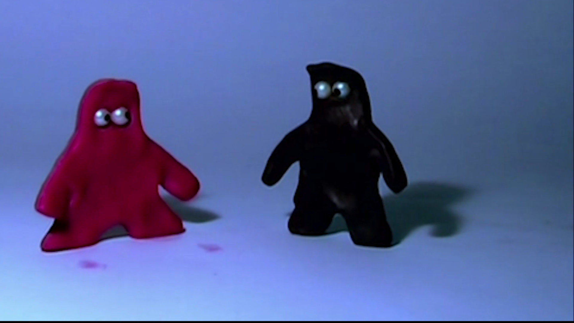 Two claymation characters against a blue background.